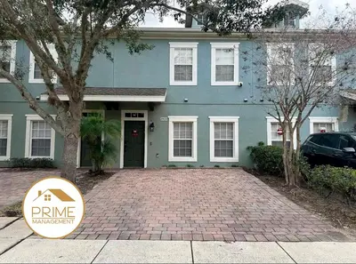 a blue house with a sign in front of it at Cozy 4bdhome By Lake Prime Location Disney in Kissimmee