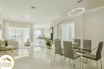 a white living room with a dining table and chairs at Renewed & Cozy 4BD Great Location near Disney in Kissimmee