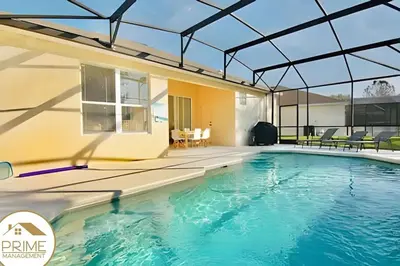 a swimming pool in a house with a glass roof at Renewed & Cozy 4BD Great Location near Disney in Kissimmee