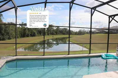 a swimming pool with a view of a golf course at Disney Villa Magical Retreat Private Pool, LakeView & Game Room in Kissimmee