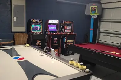 a gaming room with a pool table and arcade machines at Disney Villa Magical Retreat Private Pool, LakeView & Game Room in Kissimmee