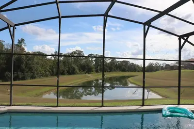 a view of a swimming pool from a glass iguanauanauanauanauana at Disney Villa Magical Retreat Private Pool, LakeView & Game Room in Kissimmee