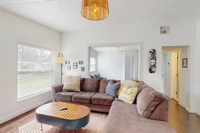 a living room with a couch and a table at Boat and Fish! Lake Druid Gem with Dog-Friendly Yard in Orlando