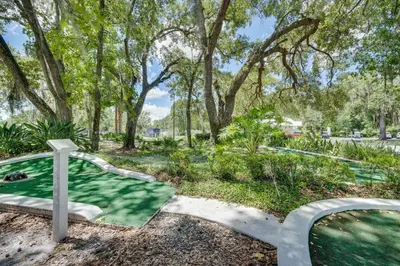 a cross in a park with trees and grass at The Hidden Gem Cottage in Kissimmee