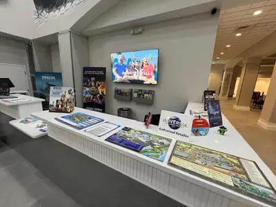 a display counter in a store with posters on it at 3 beds DisneyFree Shuttle in Orlando