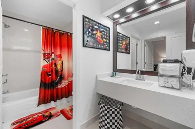 a bathroom with a sink and a mirror at 3 beds DisneyFree Shuttle in Orlando