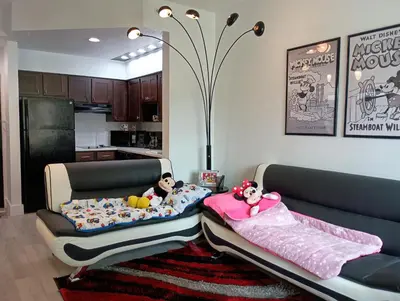 a living room with two beds with toys on them at 3 beds DisneyFree Shuttle in Orlando