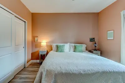 a bedroom with a large bed with green pillows at The Hub Downtown in Sanford