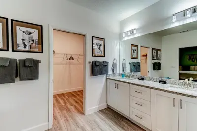 a bathroom with two sinks and a large mirror at The Hub Downtown in Sanford