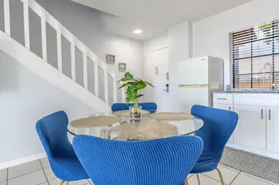 a dining room with a table and blue chairs at Charming Lakeview Retreat I in Orlando