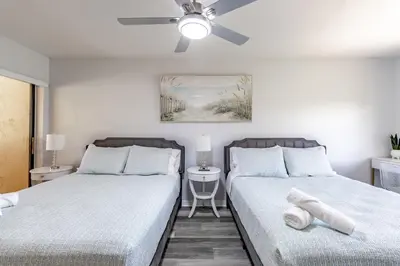 a bedroom with two beds and a ceiling fan at Charming Lakeview Retreat I in Orlando