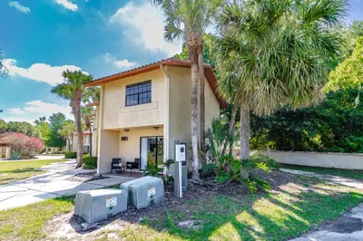 a house with palm trees in front of it at Charming Lakeview Retreat I in Orlando