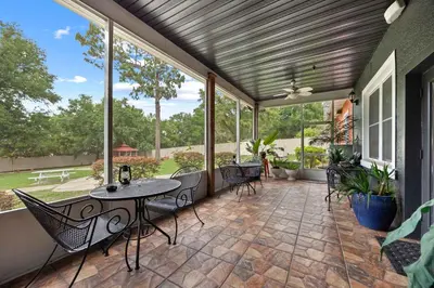 a patio with a table and chairs and windows at Banana Leaf Villa-Island Groove-Standard Suite in Orlando