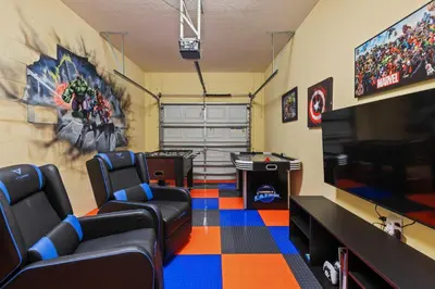 a gaming room with chairs and a flat screen tv at Perfect Disney Getaway House 6BR5BA • Private Pool at Storey Lake Resort SL4788 in Kissimmee