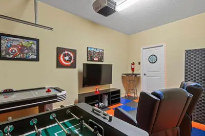 a living room with a pool table and a tv at Perfect Disney Getaway House 6BR5BA • Private Pool at Storey Lake Resort SL4788 in Kissimmee