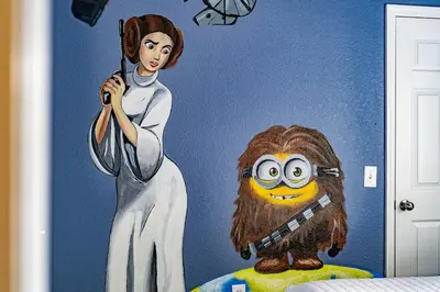 a mural of a woman holding a gun and a monkey at Windsor Hills Townhouse in Orlando