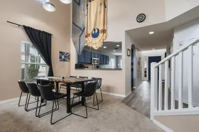 a dining room and kitchen with a table and chairs at Attention Star Wars fans Amazing 6 BR pool in Kissimmee