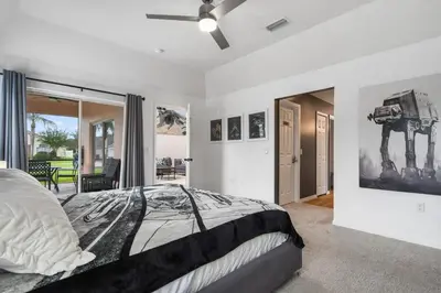 a bedroom with a bed and a ceiling fan at Attention Star Wars fans Amazing 6 BR pool in Kissimmee
