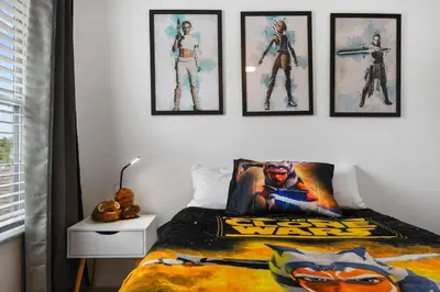 a bedroom with a spider man poster on the wall at Attention Star Wars fans Amazing 6 BR pool in Kissimmee
