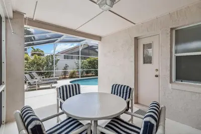 a dining room with a table and chairs and a pool at Indian Ridge- 4 bedroom home with Game Room in Orlando