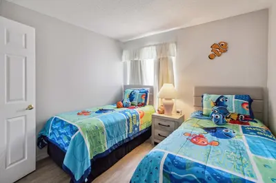 a bedroom with two beds and a dresser at Indian Ridge- 4 bedroom home with Game Room in Orlando