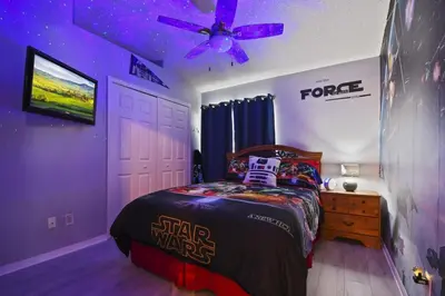 a star wars bedroom with a bed and a ceiling fan at Themed 4BR house pool game room 10 min Disney in Orlando