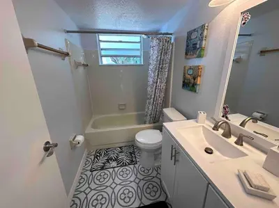 a bathroom with a sink and a toilet and a shower at Disney's Townhome in Kissimmee