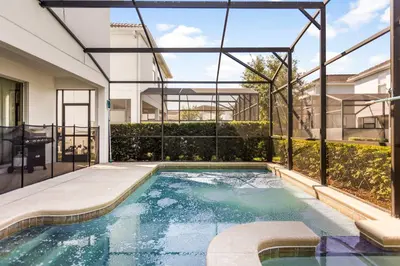 a swimming pool in the middle of a house at Dream Getaway Modern 6-Bedroom Vacation Home in Kissimmee