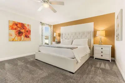 a white bedroom with a bed and a window at Dream Getaway Modern 6-Bedroom Vacation Home in Kissimmee