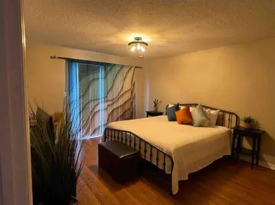 a bedroom with a bed and a window at Disney enchantment getaway in Kissimmee