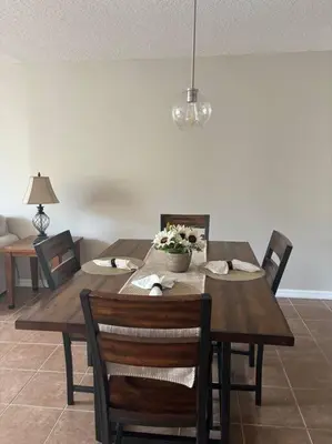 a wooden table with chairs and a dining room at Disney enchantment getaway in Kissimmee