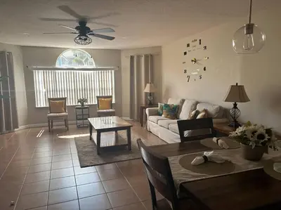 a living room with a couch and a table at Disney enchantment getaway in Kissimmee