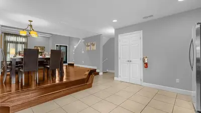 a dining room and living room with a table and chairs at Sunny Stay in FL - 4-Bedroom Townhome by Disney! in Orlando