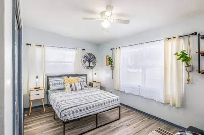 a bedroom with a bed and a ceiling fan at Magical 3BR Orlando Getaway Kitchen Near Parks in Orlando