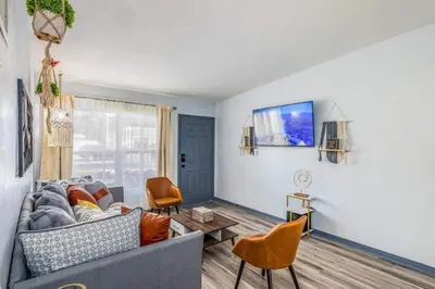 a living room with a couch and a table at Magical 3BR Orlando Getaway Kitchen Near Parks in Orlando
