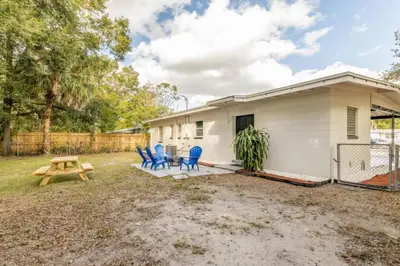 a small white house with blue chairs and a picnic table at Magical 3BR Orlando Getaway Kitchen Near Parks in Orlando