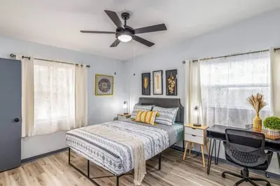a bedroom with a bed and a ceiling fan at Magical 3BR Orlando Getaway Kitchen Near Parks in Orlando