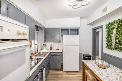 a kitchen with a white refrigerator and a table at Magical 3BR Orlando Getaway Kitchen Near Parks in Orlando
