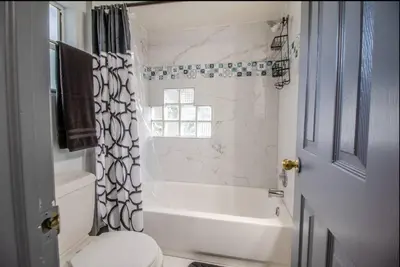 a bathroom with a tub and a toilet and a shower at Orlando 3BR2BA Family Stay with Big Savings in Orlando