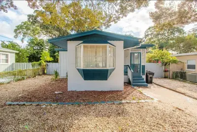 a small white house with a blue roof at Orlando 3BR2BA Family Stay with Big Savings in Orlando