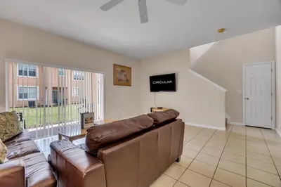 a living room with a couch and a television at RO2707BD - 4Bedrms - Regal Oaks in Orlando