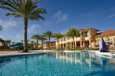 a swimming pool with palm trees and a building at RO2707BD - 4Bedrms - Regal Oaks in Orlando