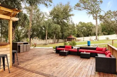 a patio with couches and chairs on a wooden deck at Banana Leaf Villa-Island groove-Standard room in Orlando