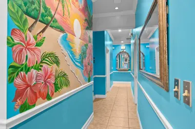 a hallway with blue walls and a mural of flowers at Banana Leaf Villa-Island groove-Standard room in Orlando