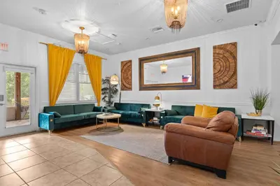a living room with green couches and a mirror at Banana Leaf Villa-Vintage Vibes Suites in Orlando