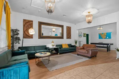 a living room with green couches and a piano at Banana Leaf Villa-Vintage Vibes Suites in Orlando