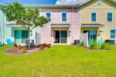 a house with a lawn in front of it at about 11 Mi to Disney Bright Kissimmee Townhome! in Orlando