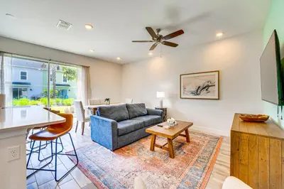 a living room with a couch and a table at about 11 Mi to Disney Bright Kissimmee Townhome! in Orlando