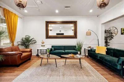 a living room with a green couch and a table at Banana Leaf Villa-Marley Junior Suite with Living Room in Orlando