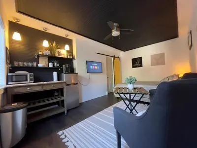 a living room with a couch and a table at Lovely Spacious Guesthouse in Mills 50 District in Orlando